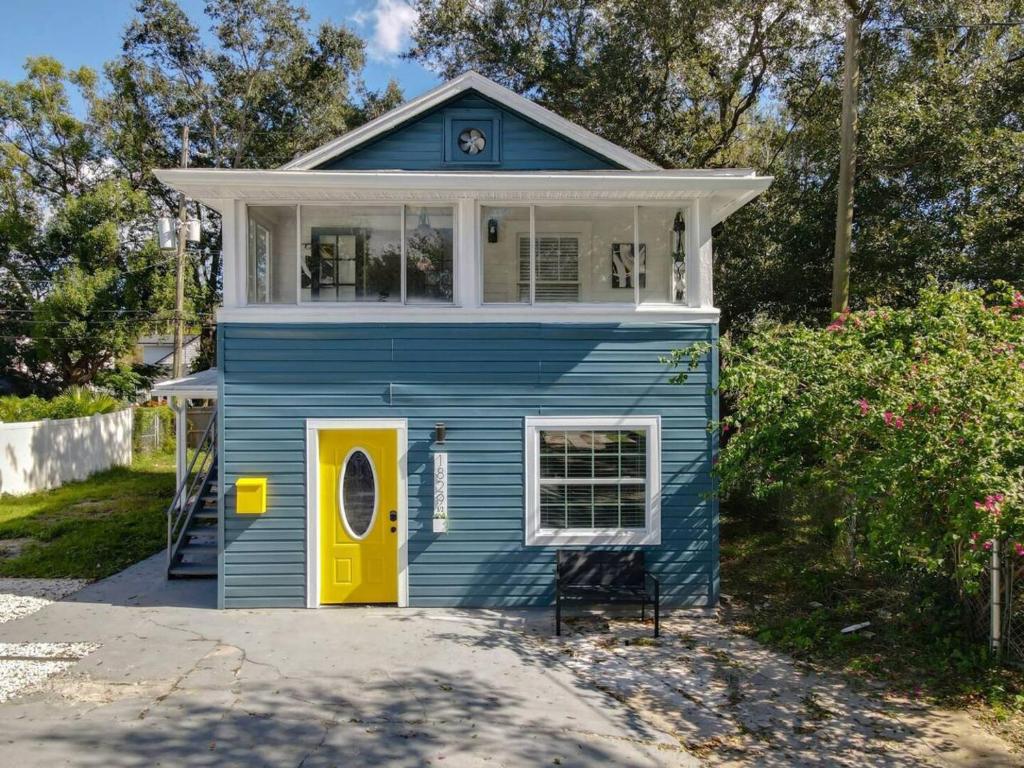 a blue tiny house with a yellow door at Budget-friendly 1br Prime Orlando Location in Orlando