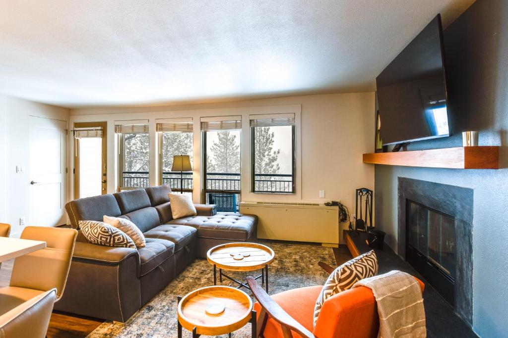 Una sala de estar con un sofá y una chimenea. en Walkable Luxury Condo at Bends 7th Mtn Resort, en Bend