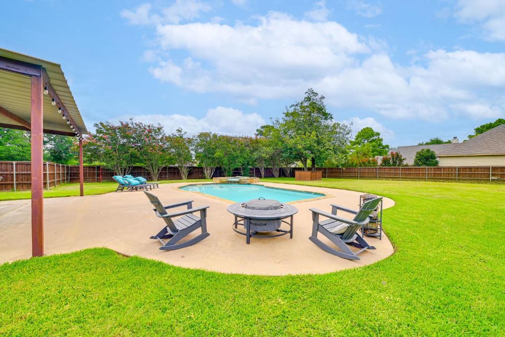a patio with a table and chairs next to a pool at Fire Pit and Sauna Spacious Lake Texoma Retreat! in Denison