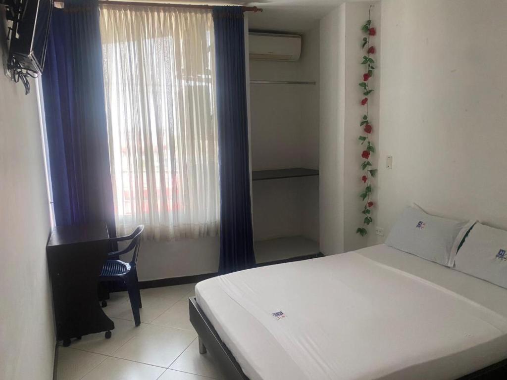 Postel nebo postele na pokoji v ubytování Hotel Milenium