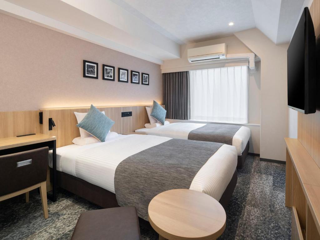 Postel nebo postele na pokoji v ubytování HOTEL MYSTAYS Iidabashi