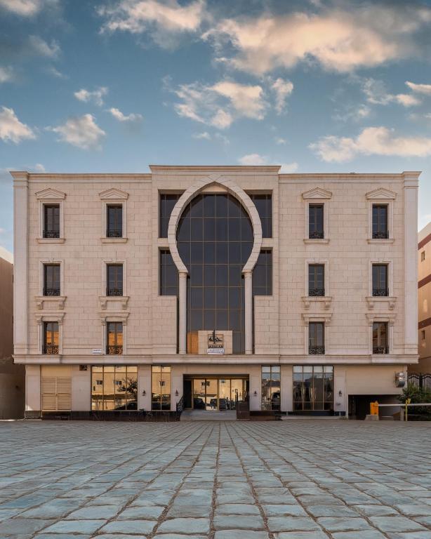 a large building with an arch in front of it at Gazala Hotel in Riyadh