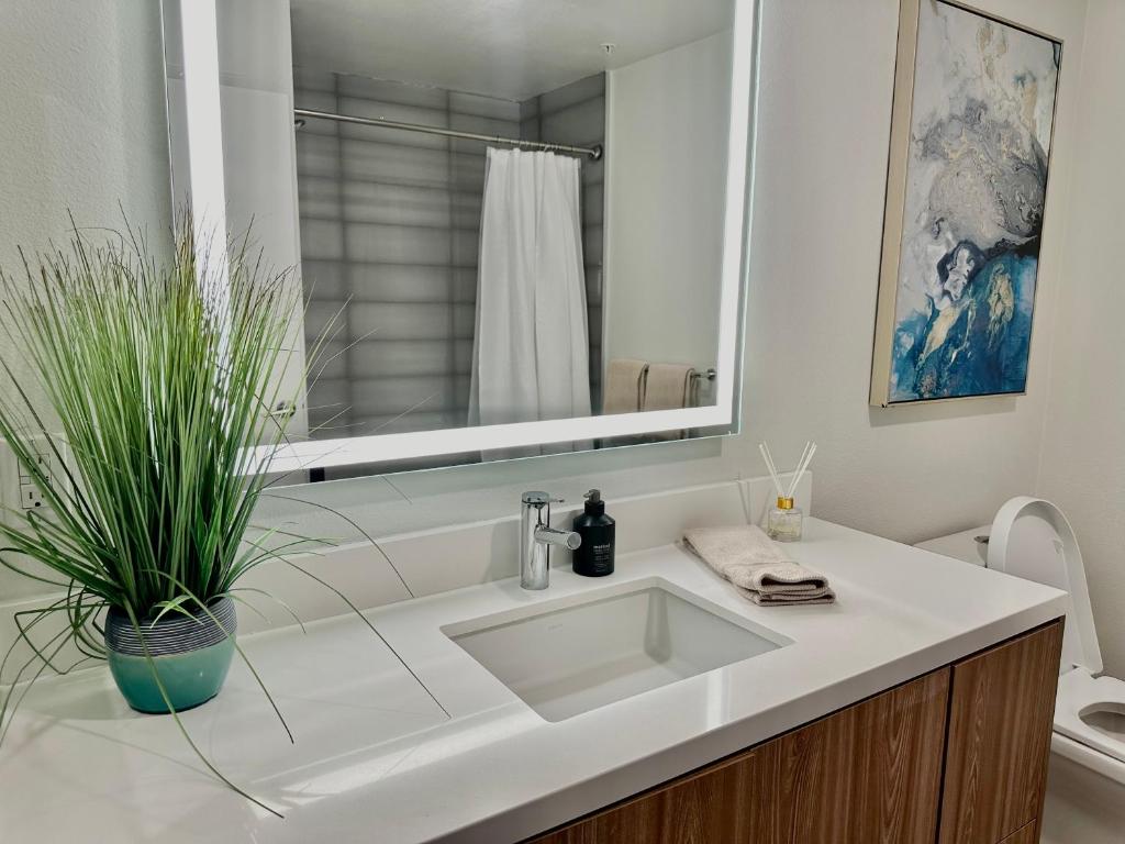 ロサンゼルスにあるCozy apartment in Hollywoodの洗面台と鏡のある白いバスルーム