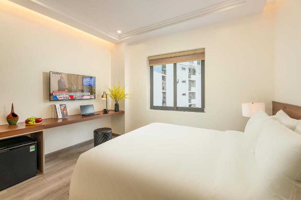 Postel nebo postele na pokoji v ubytování Gilson Hanoi Hotel