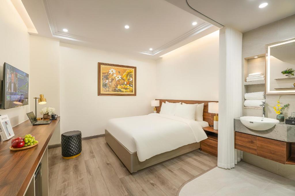 Postel nebo postele na pokoji v ubytování Gilson Hanoi Hotel