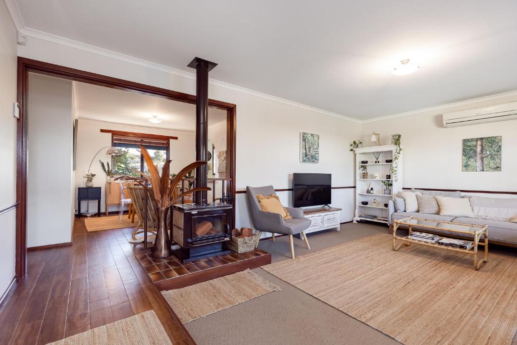 a living room with a fireplace and a couch at Roo With A View By Swan Bnb Management in Preston Beach