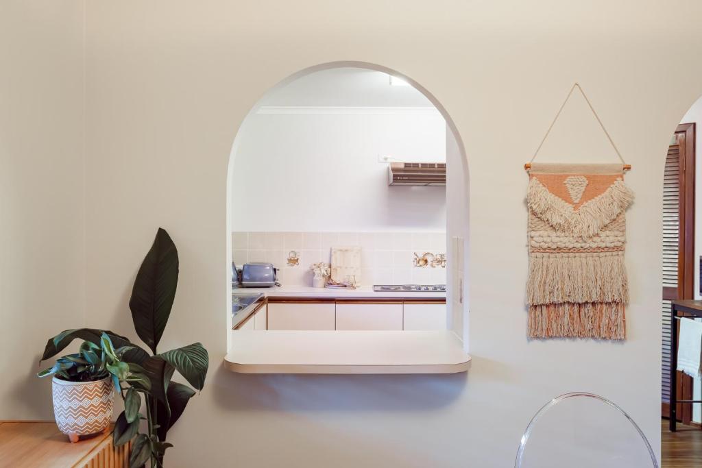 a kitchen with an archway in a white wall at Roo With A View By Swan Bnb Management in Preston Beach