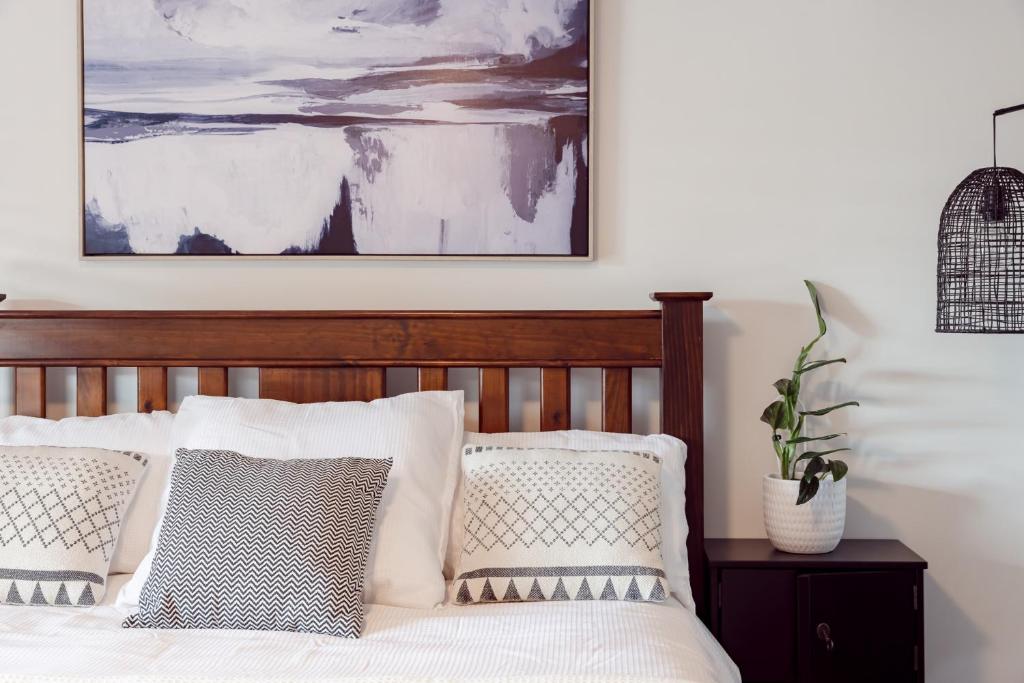 a bedroom with a bed with pillows and a painting at Roo With A View By Swan Bnb Management in Preston Beach