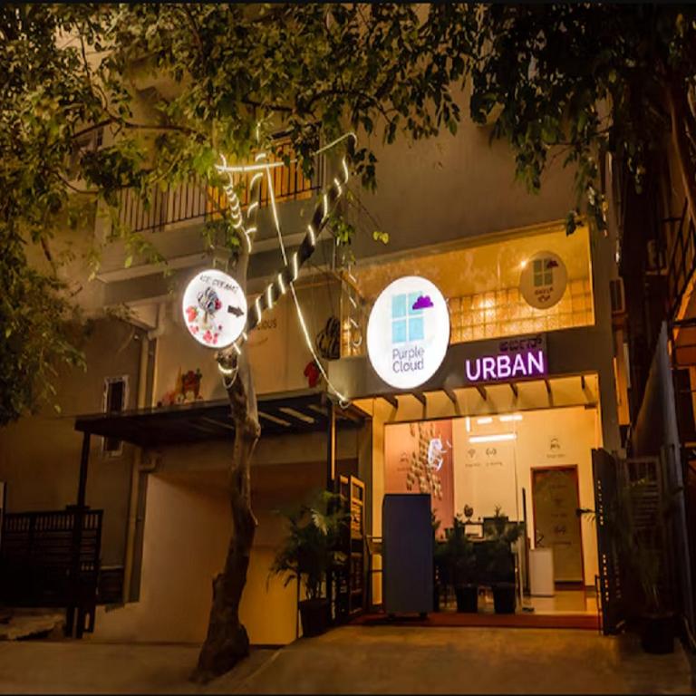 a building with a sign in front of it at Purple Cloud Urban Bangalore in Bangalore