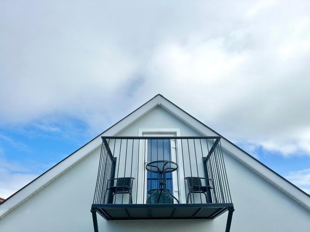 a bird cage on the side of a house at Whitestrand B&B in Malin Head