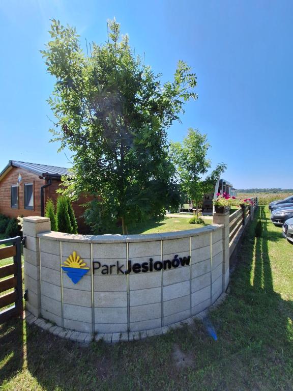 a sign that says parkestationatown behind a fence at Park Jesionów domki - Pleśna in Pleśna