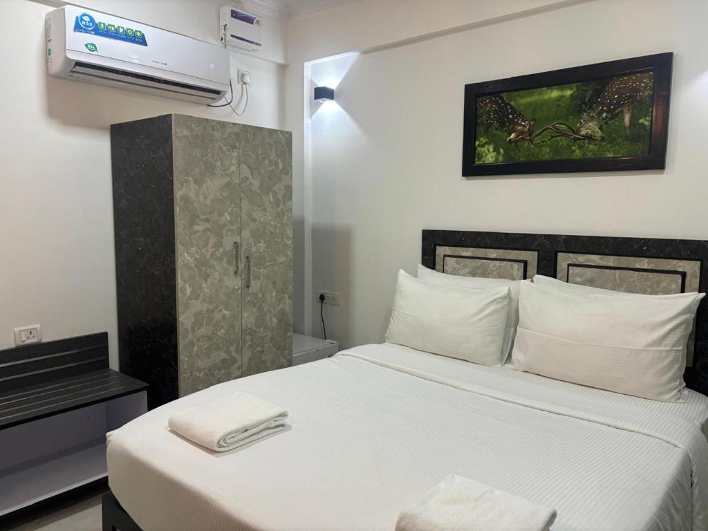 Postel nebo postele na pokoji v ubytování Henmil Hotel