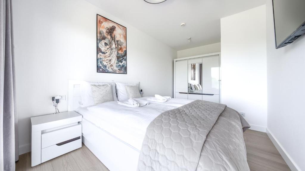 Posteľ alebo postele v izbe v ubytovaní Apartamenty Sun & Snow Polanki Aqua z basenem