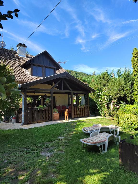 a house with a dog in the yard at RichiLak in Visegrád