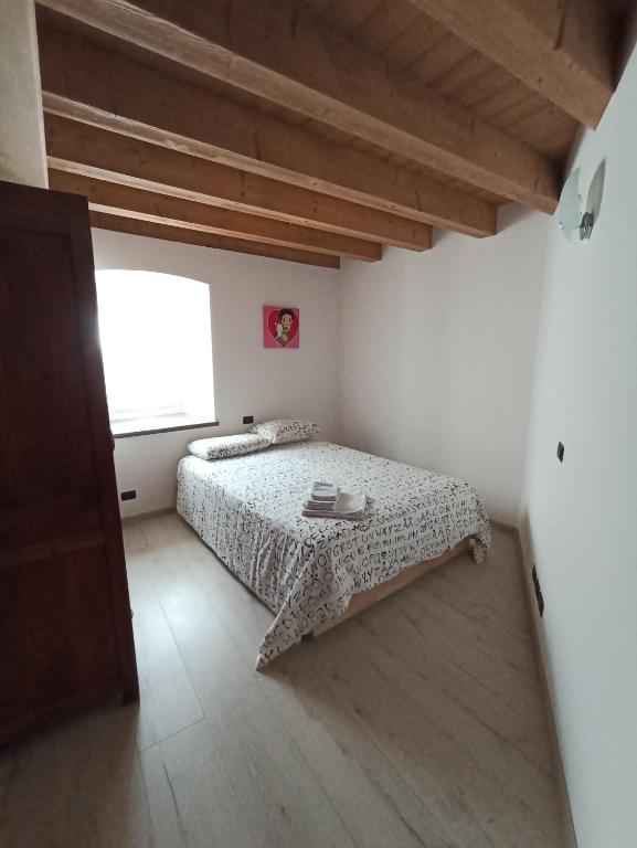Postel nebo postele na pokoji v ubytování Appartamento Lorena a Mezzano