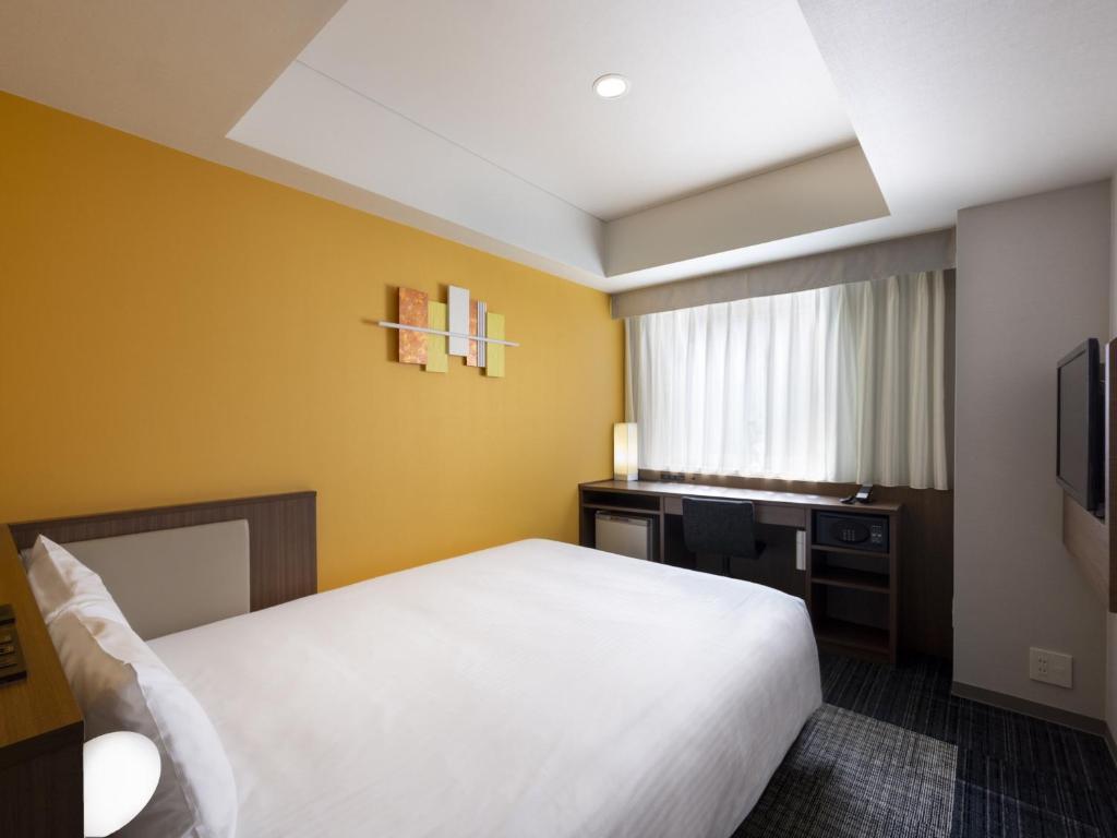 Postel nebo postele na pokoji v ubytování ibis Styles Kyoto Shijo