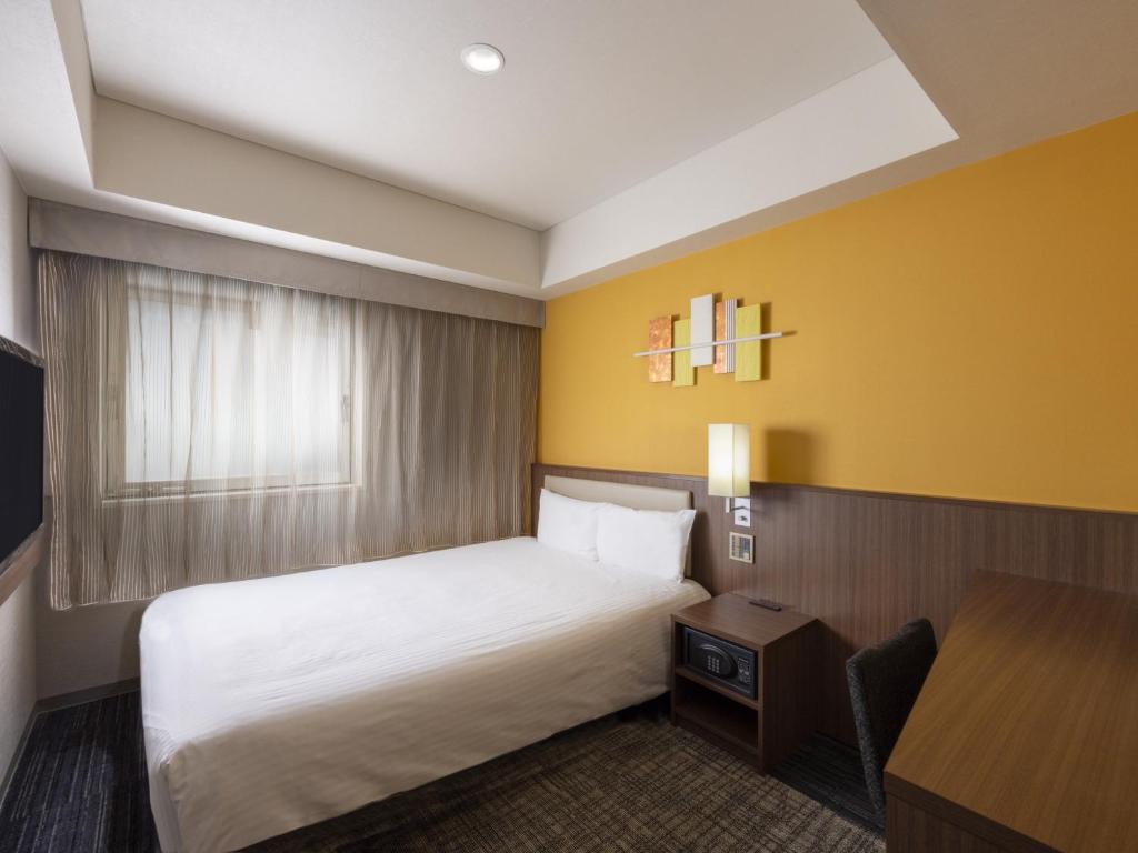 Postel nebo postele na pokoji v ubytování ibis Styles Kyoto Shijo