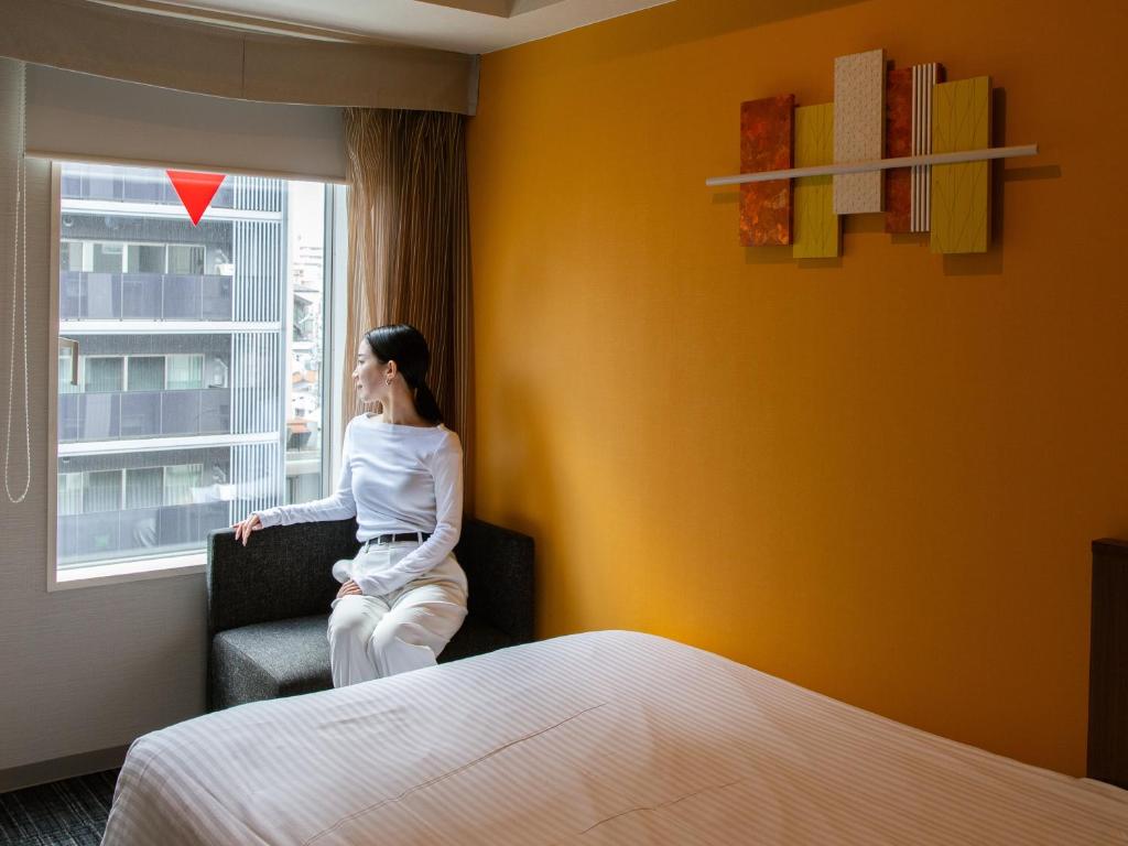 Postel nebo postele na pokoji v ubytování ibis Styles Kyoto Shijo