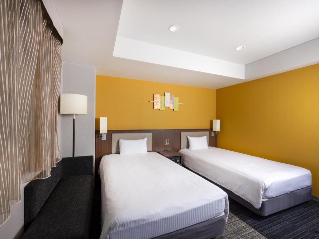 Postel nebo postele na pokoji v ubytování ibis Styles Kyoto Shijo