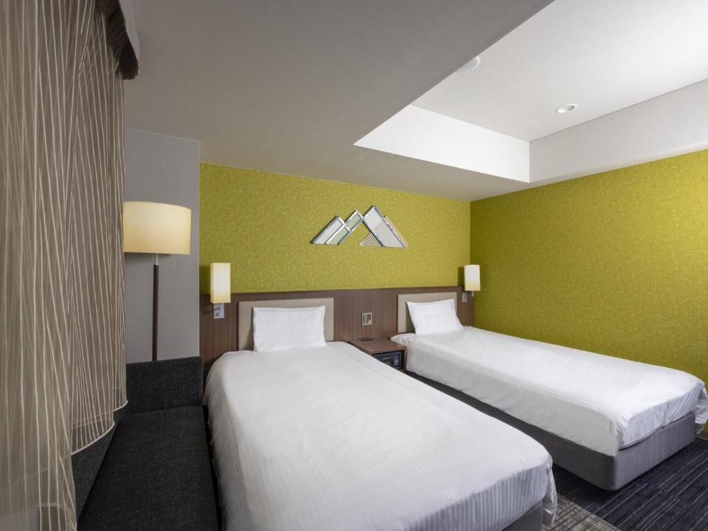 Postel nebo postele na pokoji v ubytování ibis Styles Kyoto Shijo
