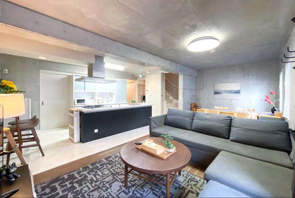 a living room with a couch and a table at Uhome Otsuka Villa in Tokyo