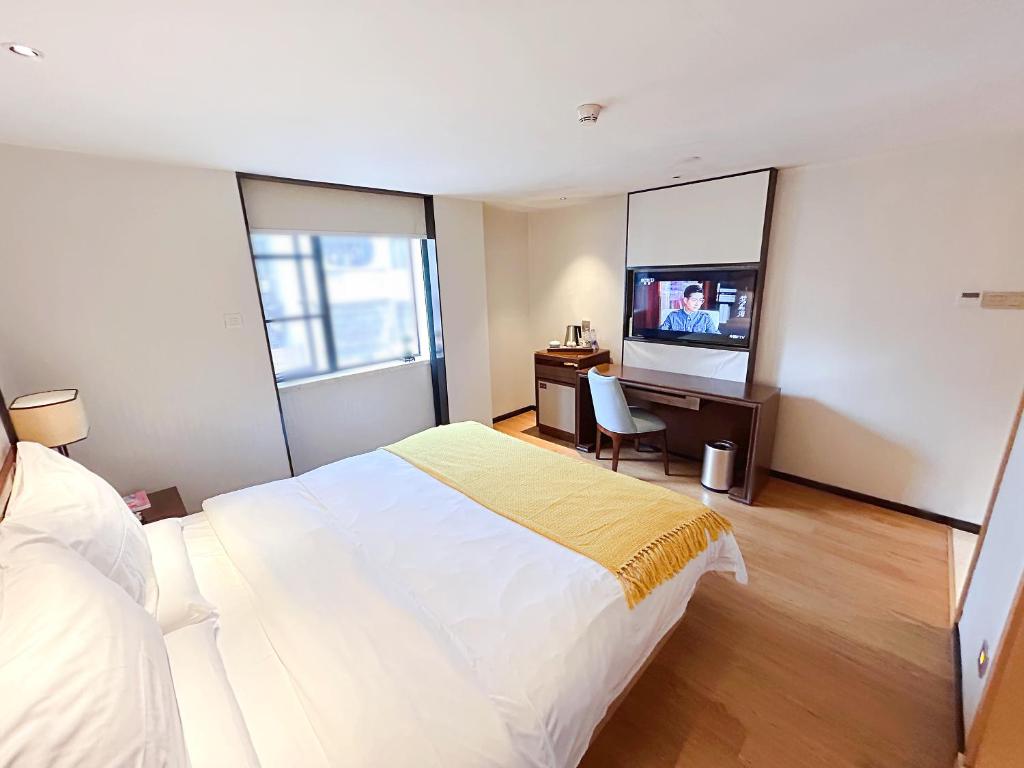 Postel nebo postele na pokoji v ubytování Guangzhou City Join Hotel Shipai Qiao metro Branch
