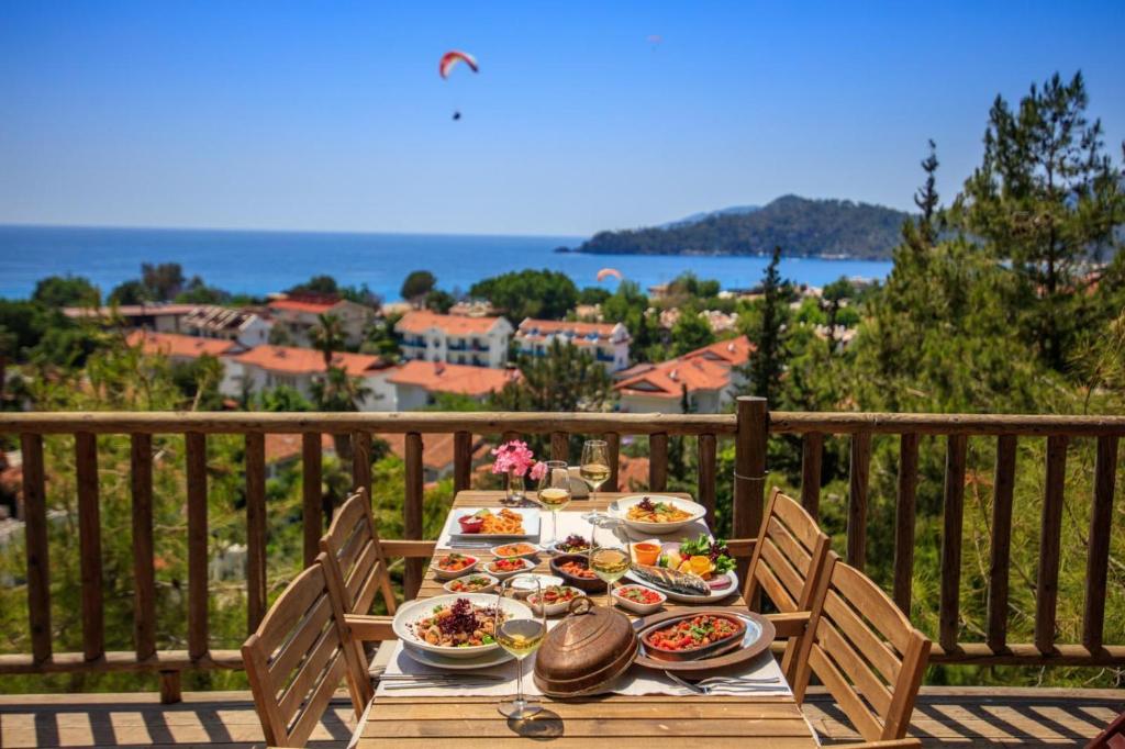 a table with plates of food on a balcony at Symbola Oludeniz Beach Hotel in Oludeniz