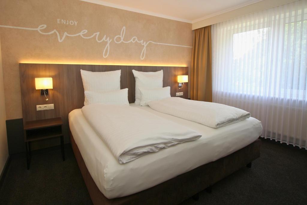 Postel nebo postele na pokoji v ubytování Hotel Graf Balduin