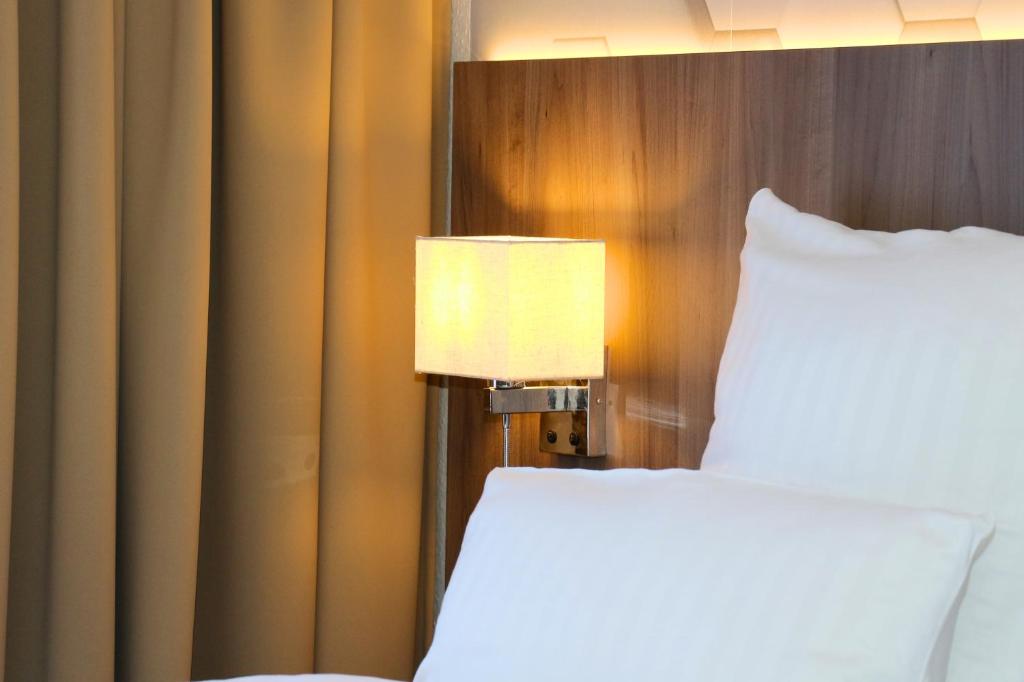 Postel nebo postele na pokoji v ubytování Hotel Graf Balduin
