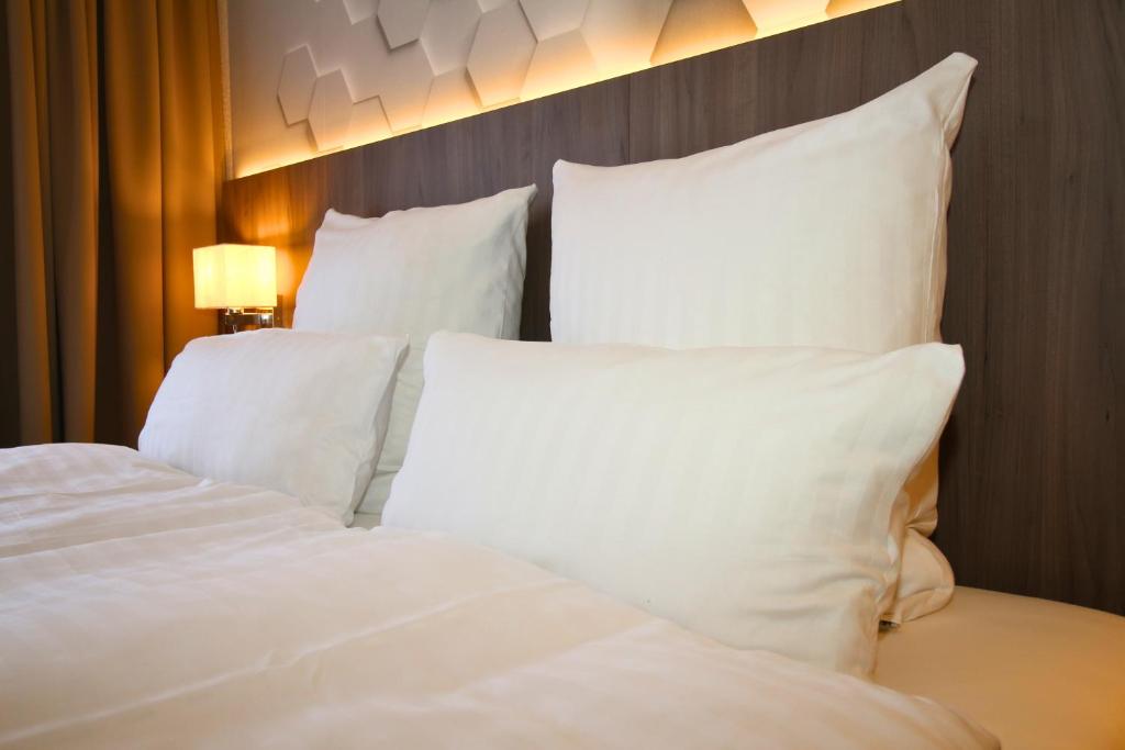 Postel nebo postele na pokoji v ubytování Hotel Graf Balduin