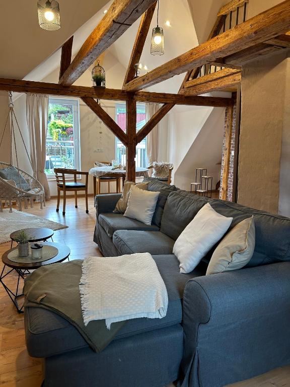 a living room with a blue couch and a table at Ferienhaus Klaus in Kirchenlamitz