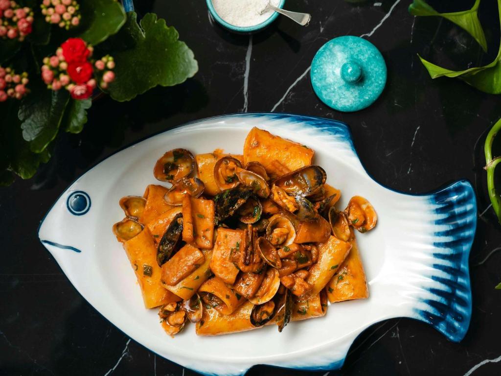 a plate of food with mushrooms on a table at Sofitel Luxembourg Europe in Luxembourg
