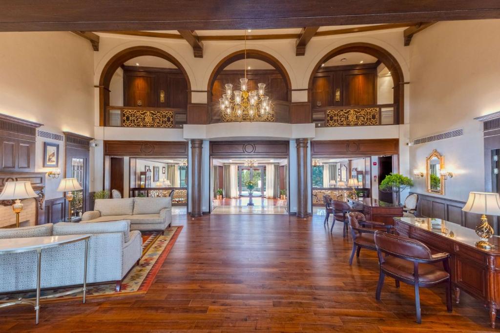 a living room filled with furniture and a chandelier at Namah Nainital, a member of Radisson Individuals Retreats in Nainital