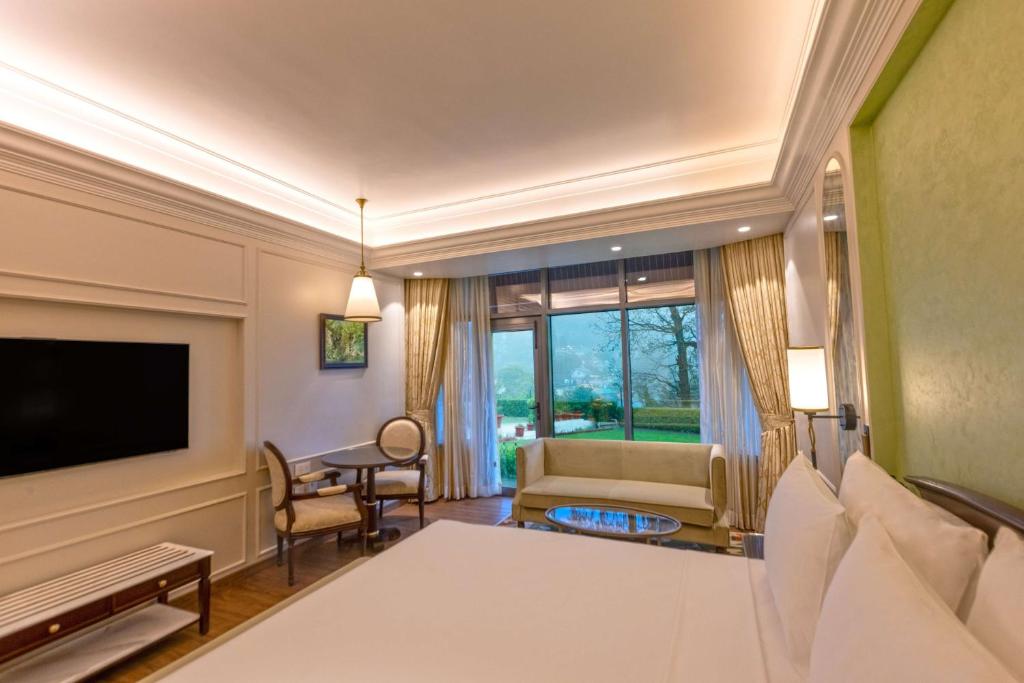 a large living room with a couch and a television at Namah Nainital, a member of Radisson Individuals Retreats in Nainital