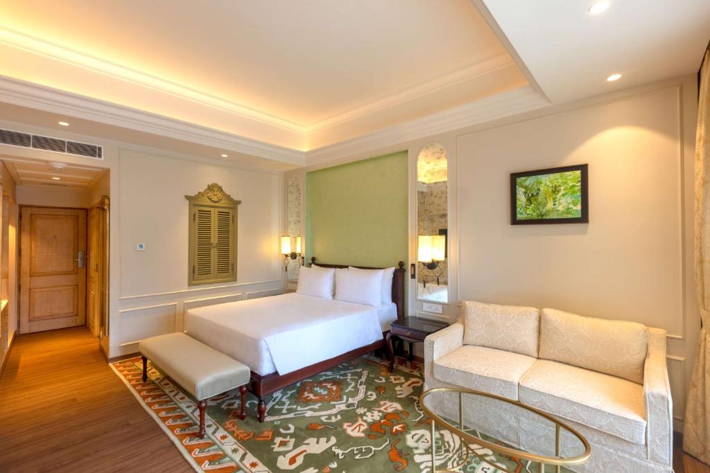a hotel room with a bed and a couch at Namah Nainital, a member of Radisson Individuals Retreats in Nainital