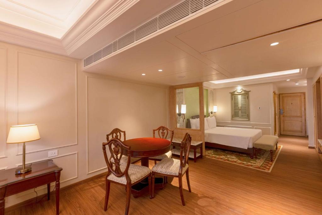a room with a table and chairs and a bedroom at Namah Nainital, a member of Radisson Individuals Retreats in Nainital