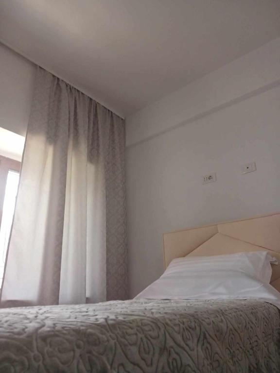 Postel nebo postele na pokoji v ubytování Bujtina Dalmacia