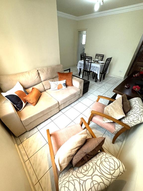 a living room with two couches and a table at Cantinho da Carol - Pituba - Localização Perfeita! in Salvador