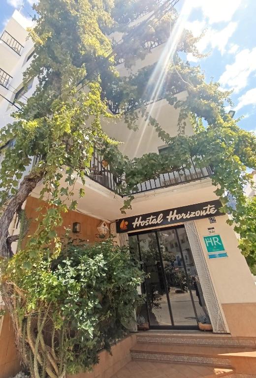 a building with a sign that reads insidehounds at Hostal Horizonte in San Antonio
