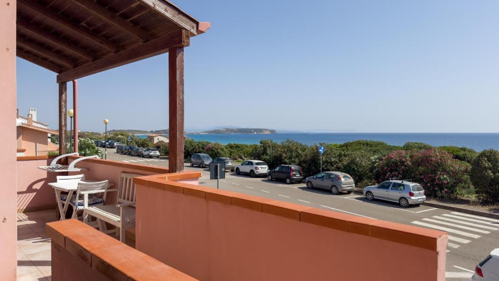 a balcony with a view of a parking lot at Sardinianworld - Frontemare Apartment-Funtana Meiga in Funtana Meiga