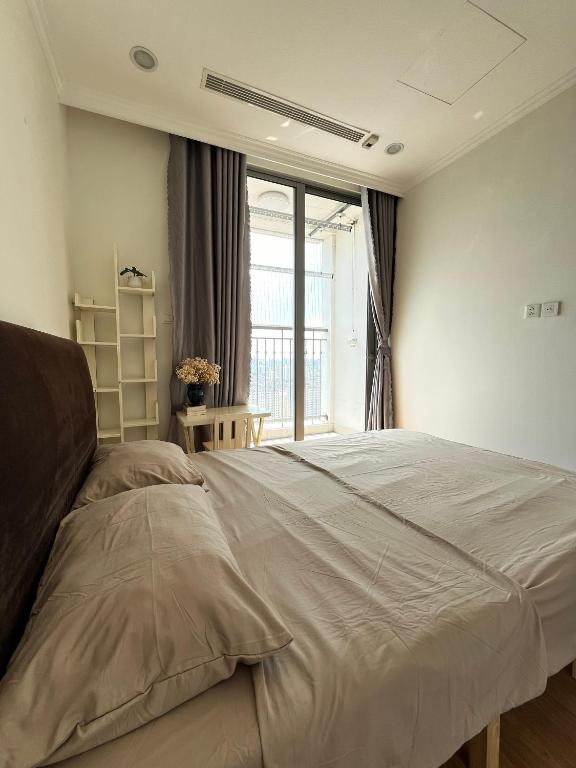 a bedroom with a large bed and a window at Park 12 Homestay in Hanoi