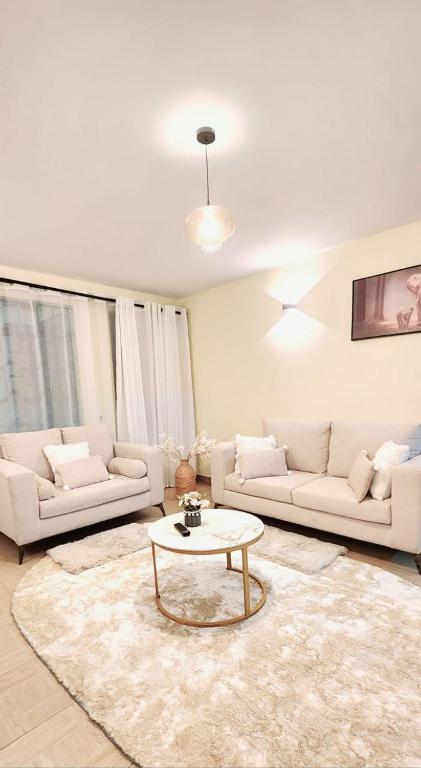 a living room with two couches and a coffee table at Golden Touch Luxury Superior in Nairobi