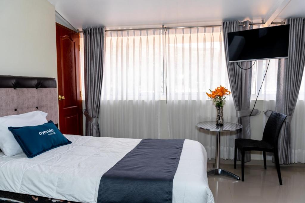 Postel nebo postele na pokoji v ubytování Hotel Luna de Oro Cusco