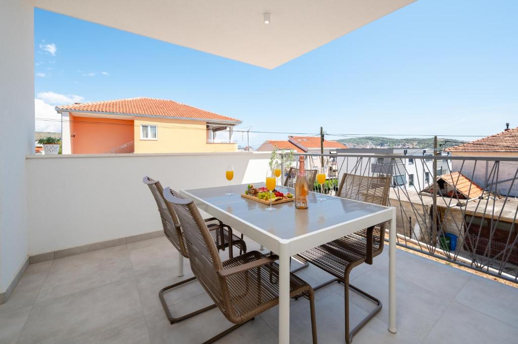 a white table and chairs on a balcony at Apartment SarAna Trogir in Trogir