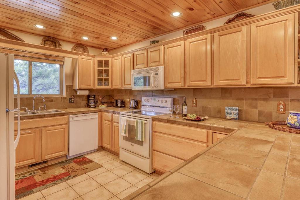 a kitchen with white appliances and wooden cabinets at 460 Hills Circle in Nutria