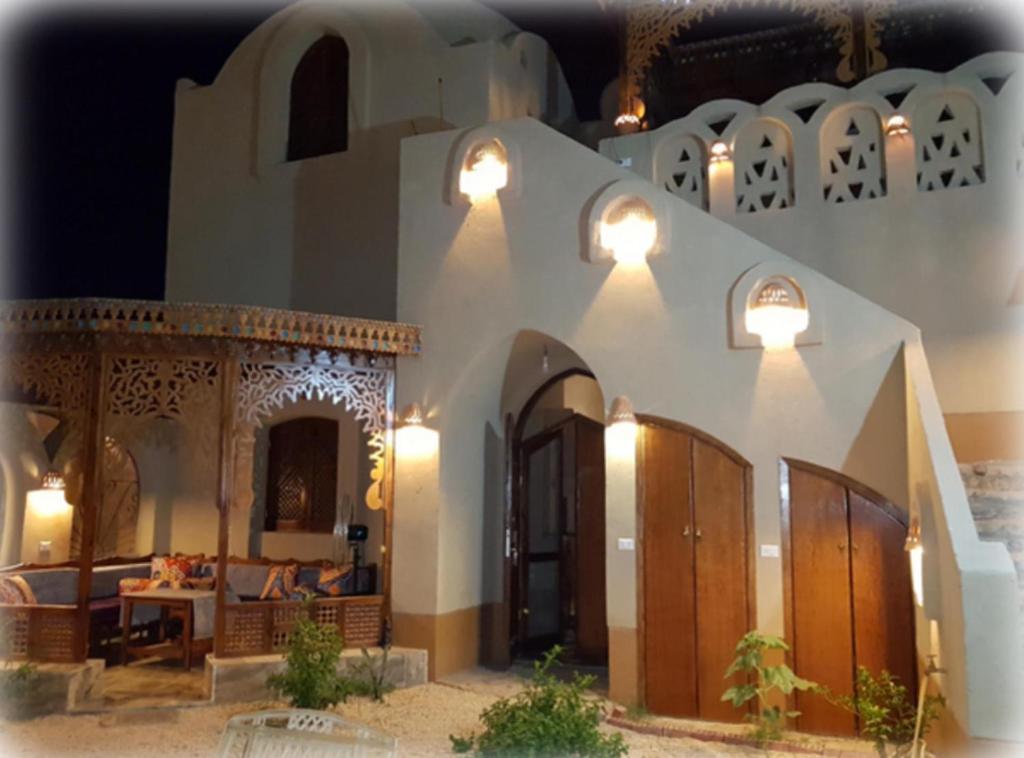 a model of a house with lights on it at Harmony Villas Sleeps 4 with Garden in Al Qurnah