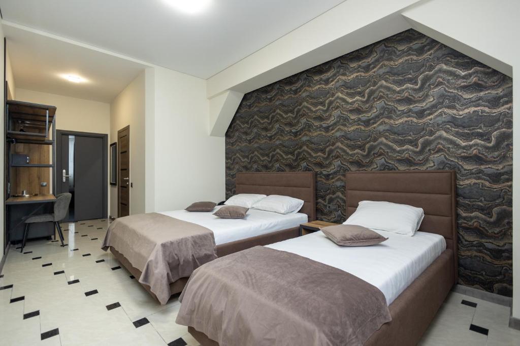 Postel nebo postele na pokoji v ubytování IRIS Hotel