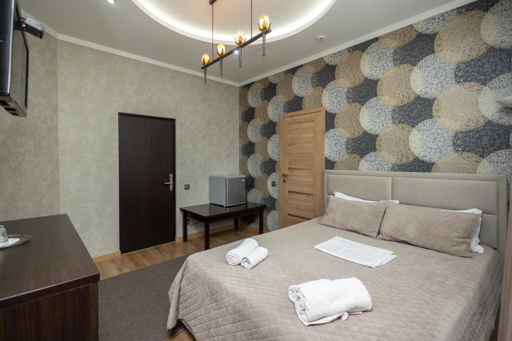 Postel nebo postele na pokoji v ubytování IRIS Hotel