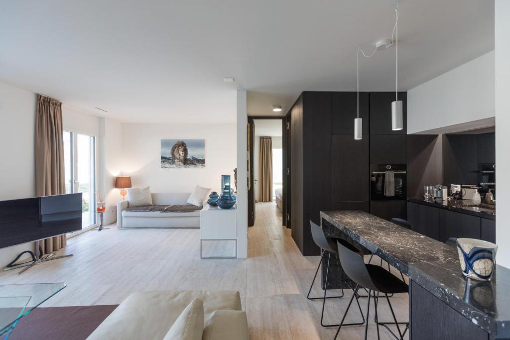 a living room with a couch and a table at Suite Appartement 713 in Ascona
