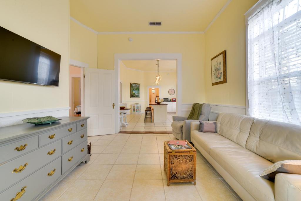a living room with a couch and a tv at Cozy Thomasville Cottage - Walk to Downtown! in Thomasville